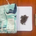 Rich, aromatic Arabica Sumbawa coffee beans from Barnaby Robson, displayed on a notepad with a gold pen for a sophisticated coffee experience. Perfect for coffee enthusiasts and connoisseurs.