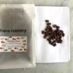Smooth roasted Pantan CUACA coffee beans from Hana Roastery with info on flavor notes, packaged in a minimalist pouch, ideal for coffee enthusiasts and specialty coffee lovers.