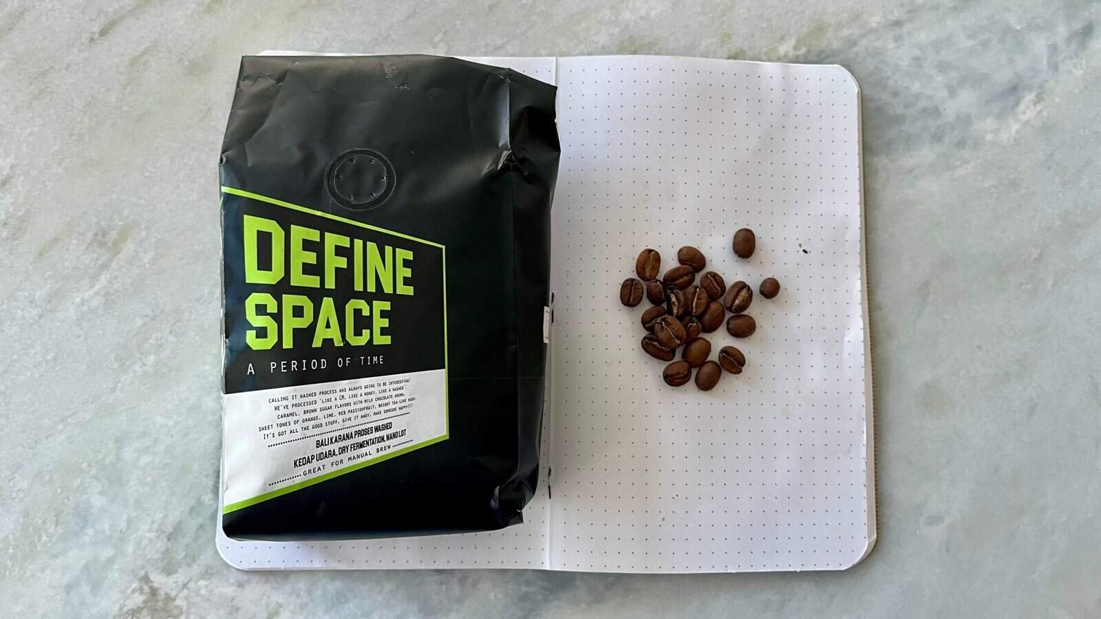 Bag of specialty coffee beans with "Define Space" label from Barnaby Robson, showcasing fresh roasted coffee, ideal for manual brewing and appreciated by coffee enthusiasts.