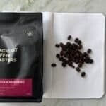 Blacklist Coffee Roasters Wanoja Kamojang premium Indonesian coffee beans on a dotted notebook with coffee beans.
